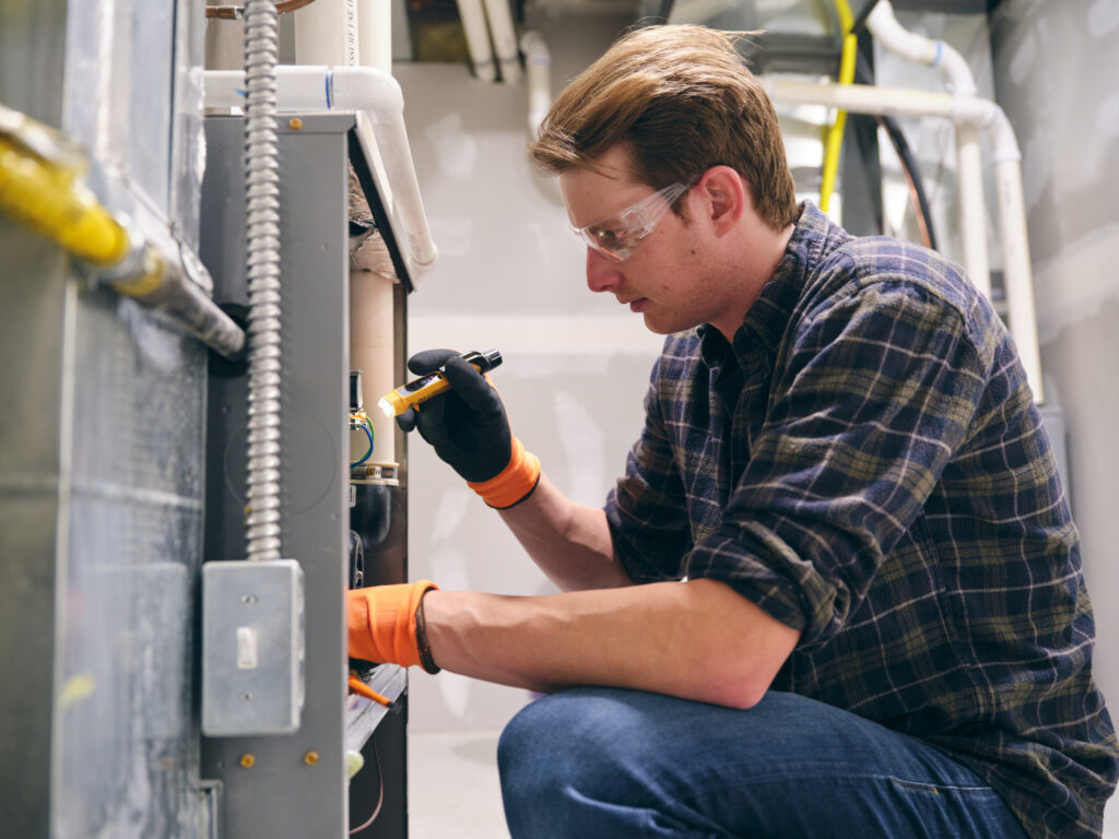 Home Repairman Working on a Furnace